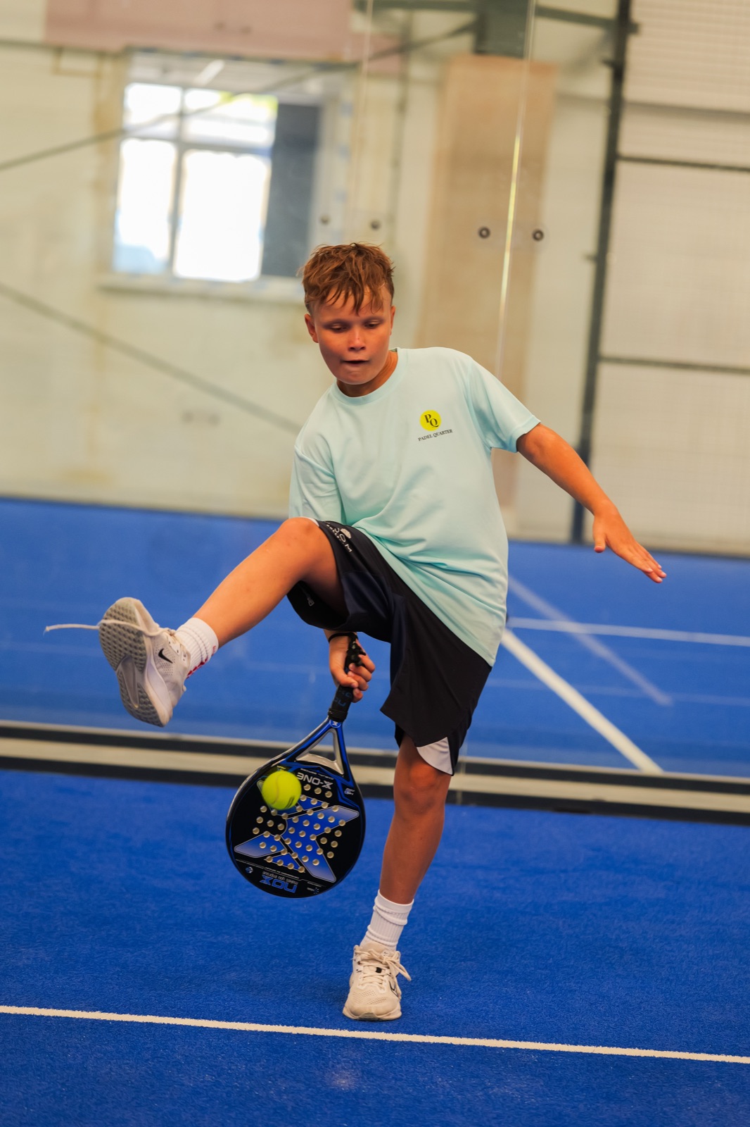 A junior player playing a trick shot